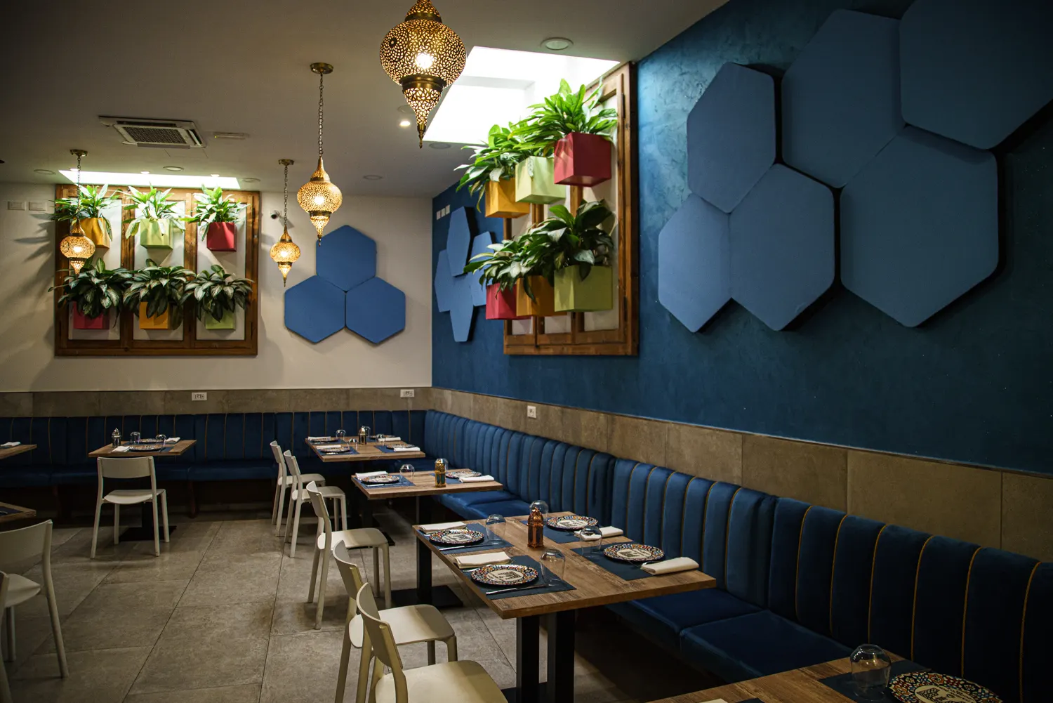 Zona pranzo con parete blu e lampade sospese